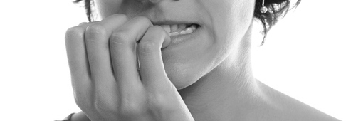 A lady biting her nail